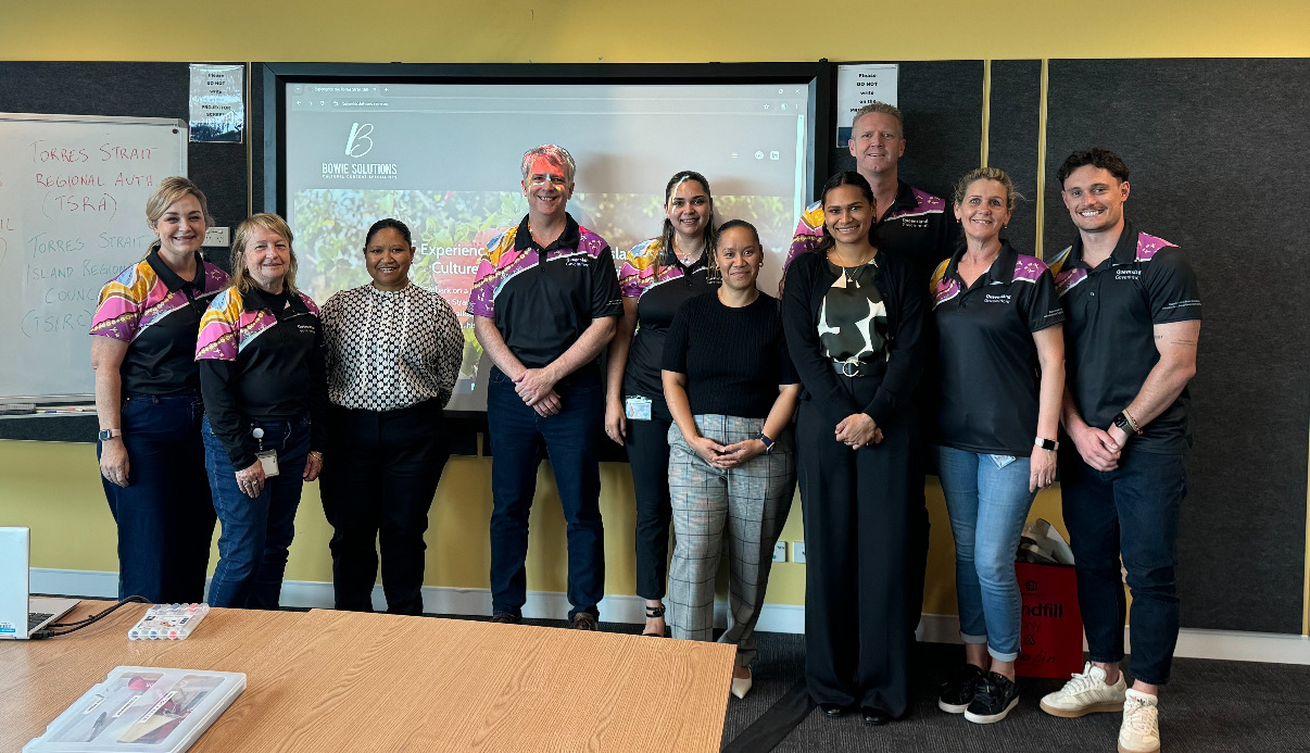 The SEQ West Regional Office and Bowie family smiling to the camera together.